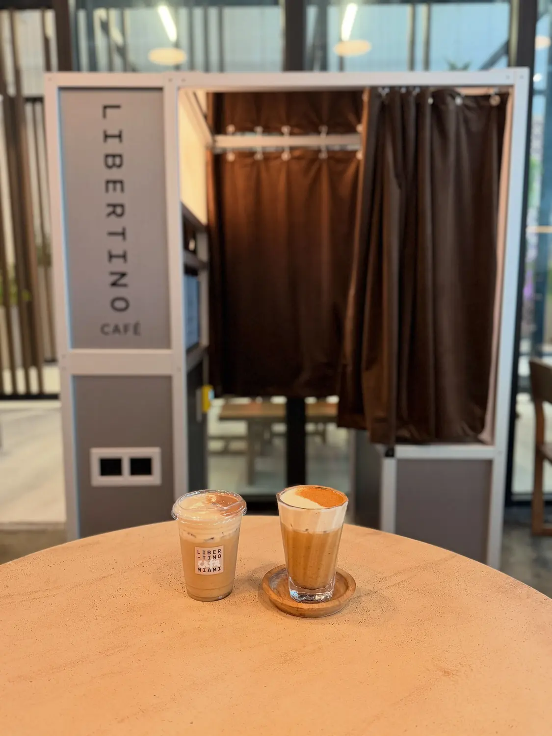 The Libertino photo booth with two coffees on a table in front