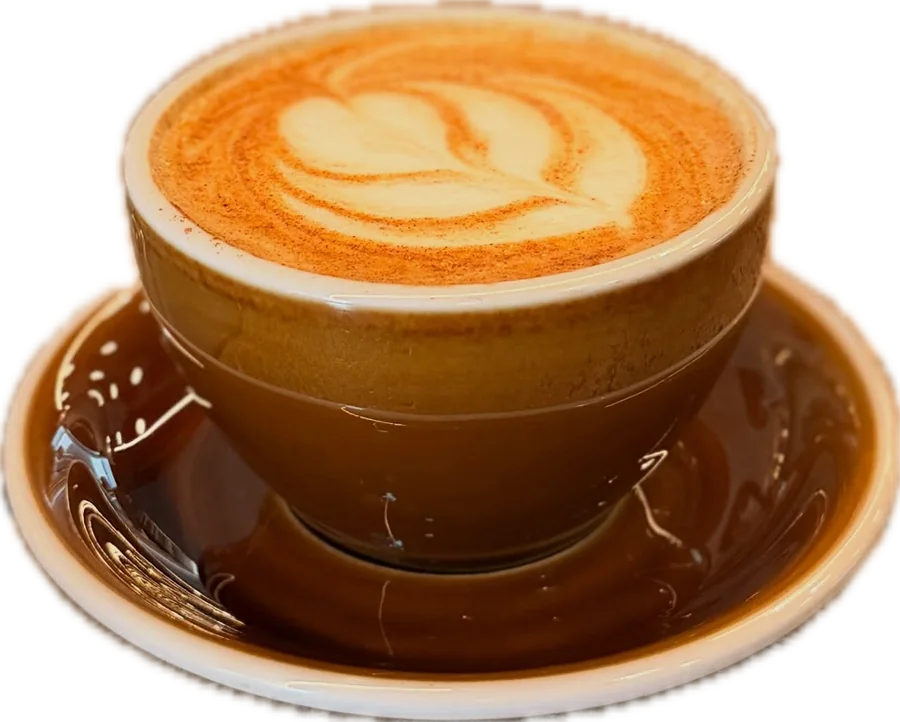 Latte with a rosetta in a ceramic cup and saucer