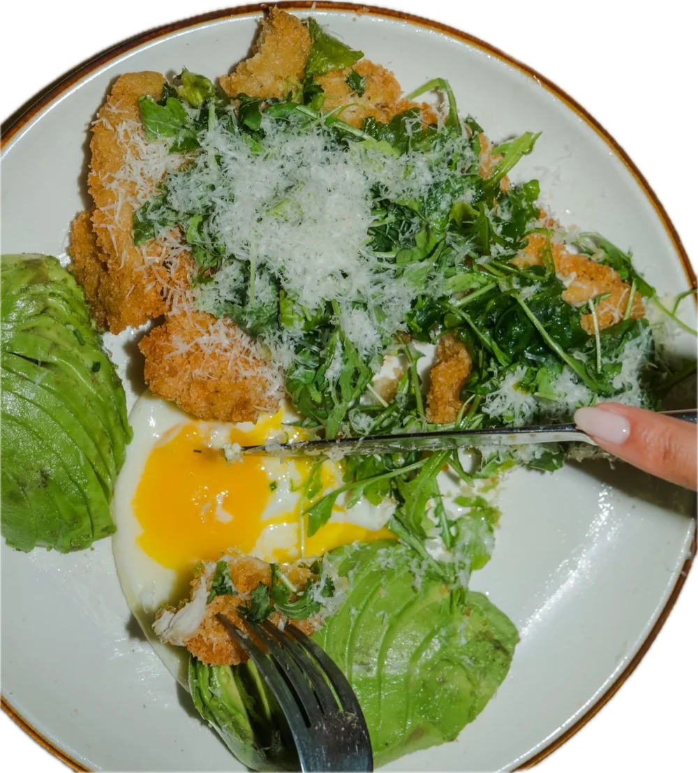Chicken milanese with arugula, parmesan, avocado and a sunny side egg