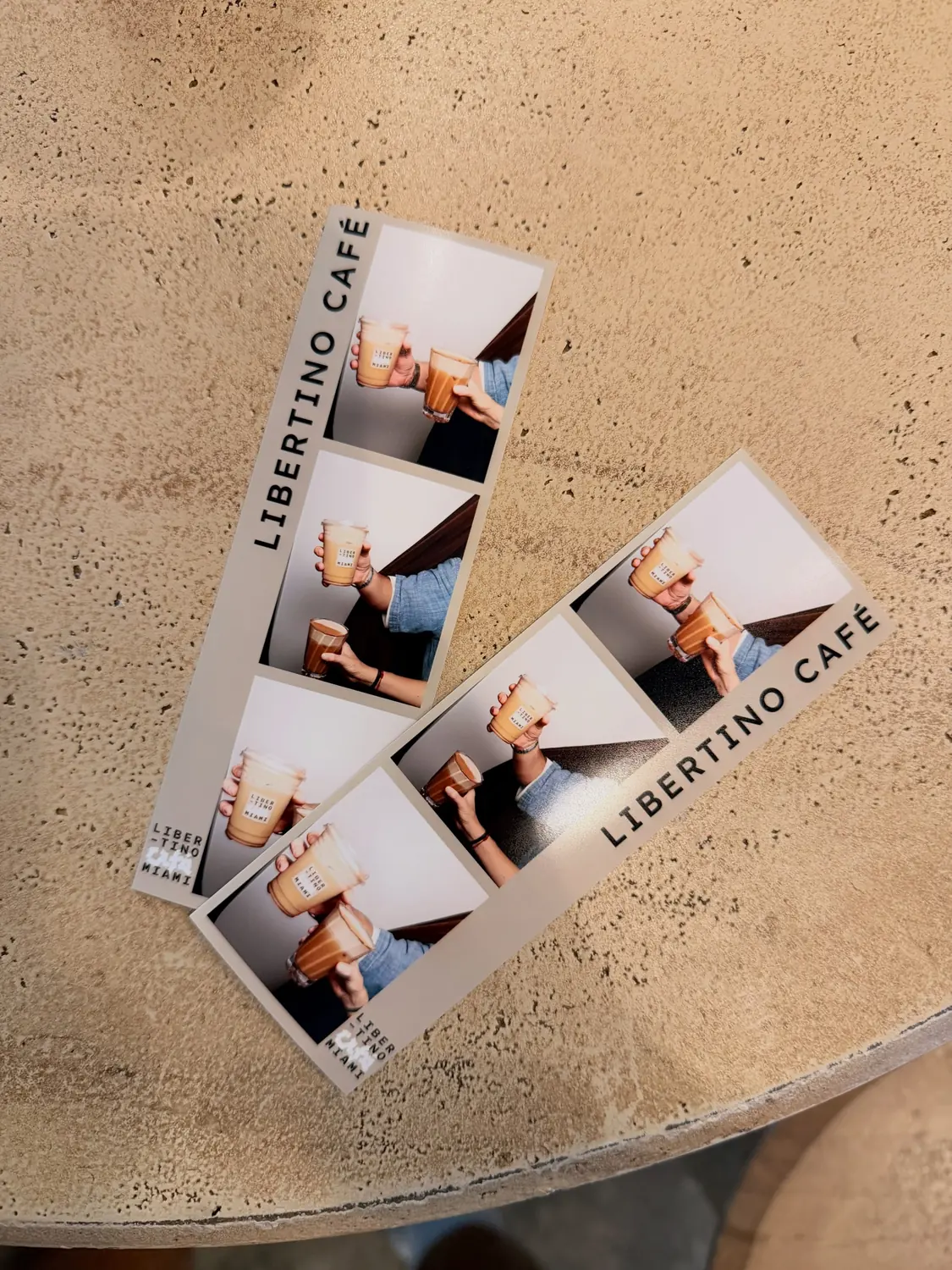 Two photo booth strips on the bar