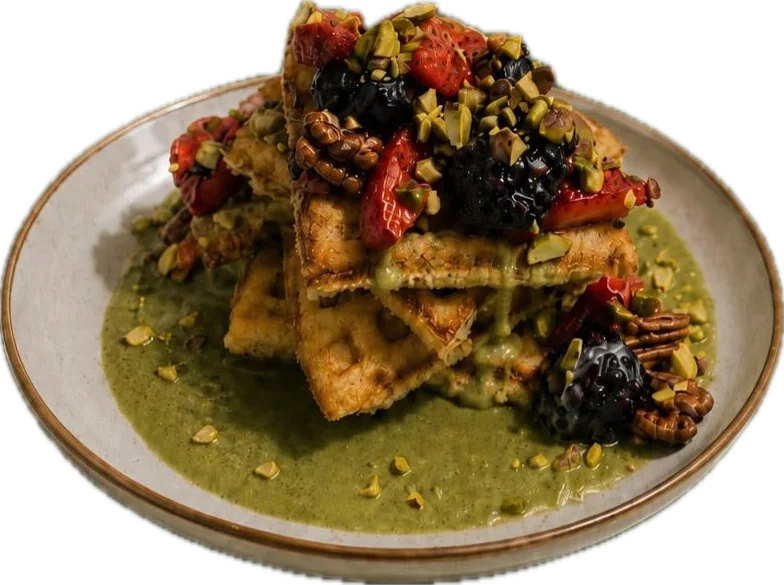Waffle with pistachio and matcha cream, berries and toasted pistachios